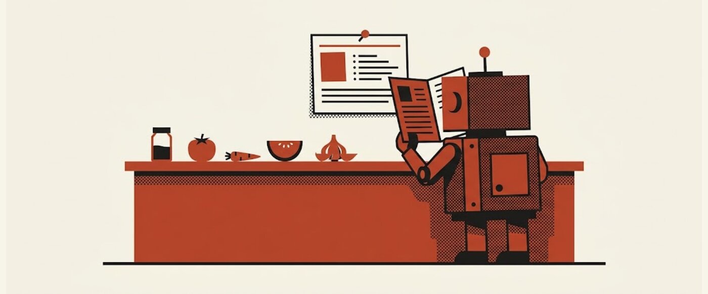 A small robot at a kitchen counter reading a recipe card